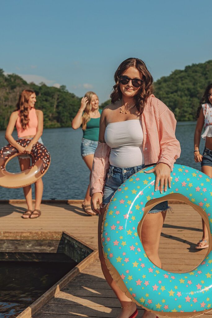 Smiling teen girl with donut float at Holliday Lake